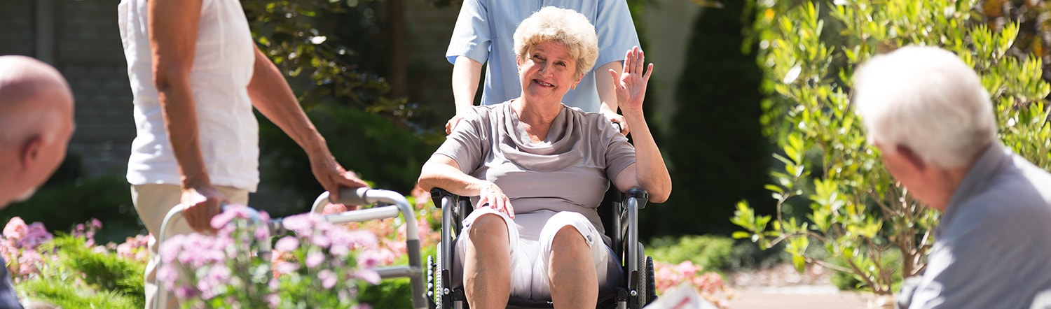 elderly woman getting pushed in wheelchair