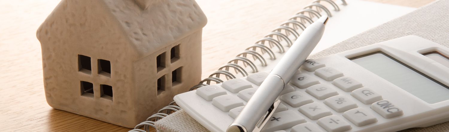 close-up of house and calculator