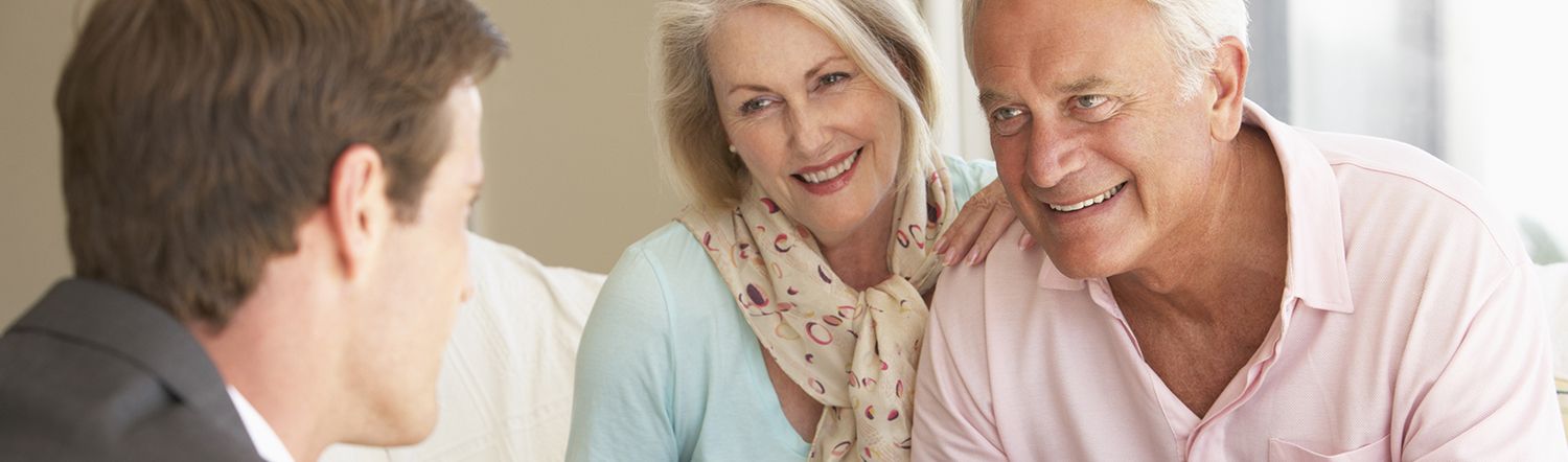 close-up of elderly couple having coversation with real estate agent