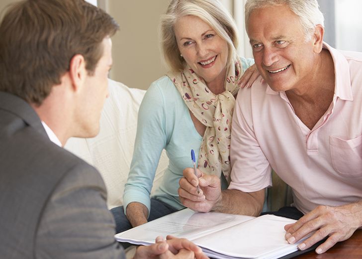 elderly couple meeting with real estate agent