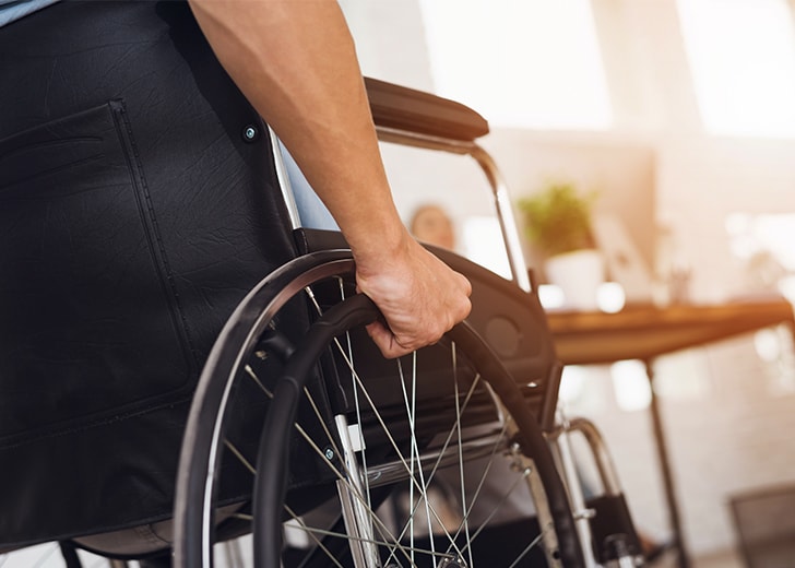 close-up of man using wheelchair