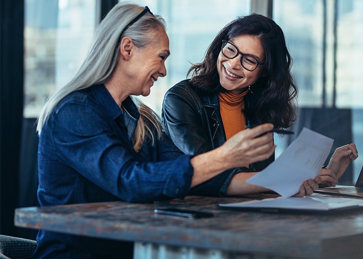 two women having a legal document meeting