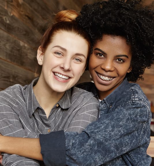 two females smiling for portrait