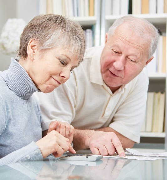 elderly couple looking over paperwork