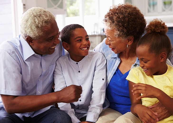 grandparents laughing with their grandchildren