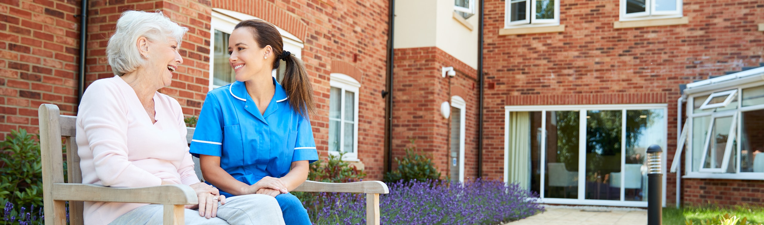 elderly woman in an assisted living facility interacts with a nurse