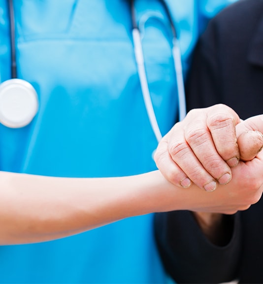 nurse and patient shaking hands