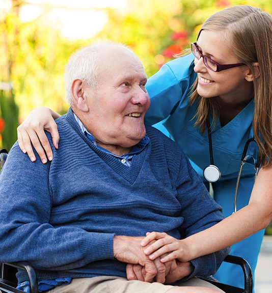 close-up of home healthcare nurse hugging elderly man