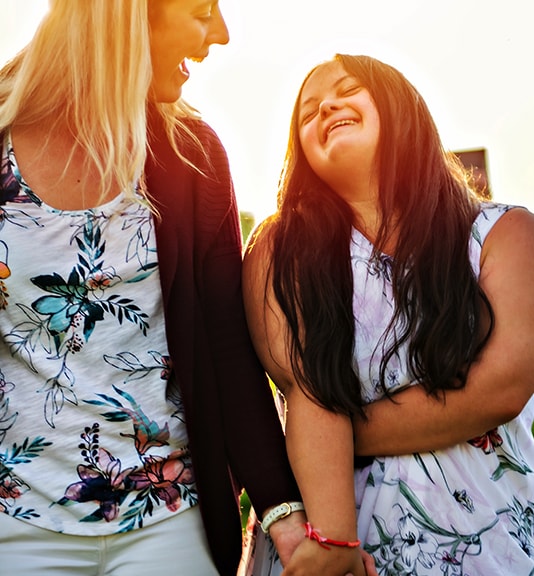 woman and a child with special needs smiling for portrait