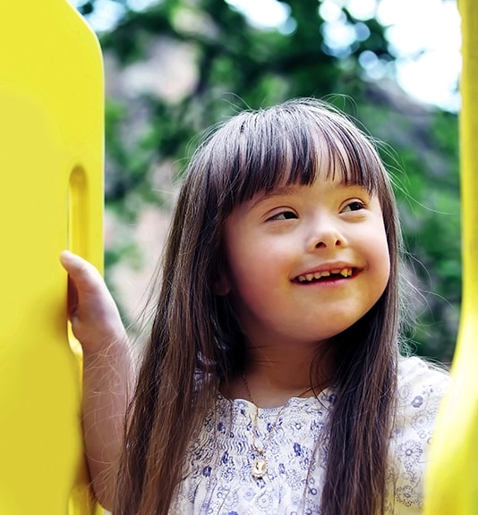 little girl with special needs smiling