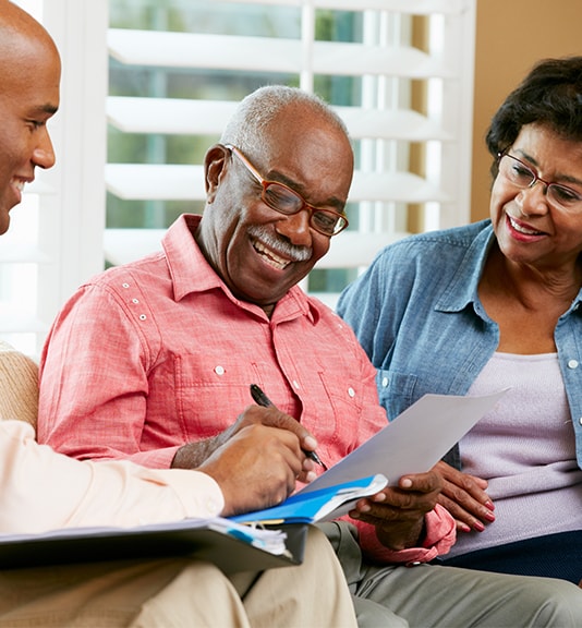 couple going over paperwork and information with gentleman