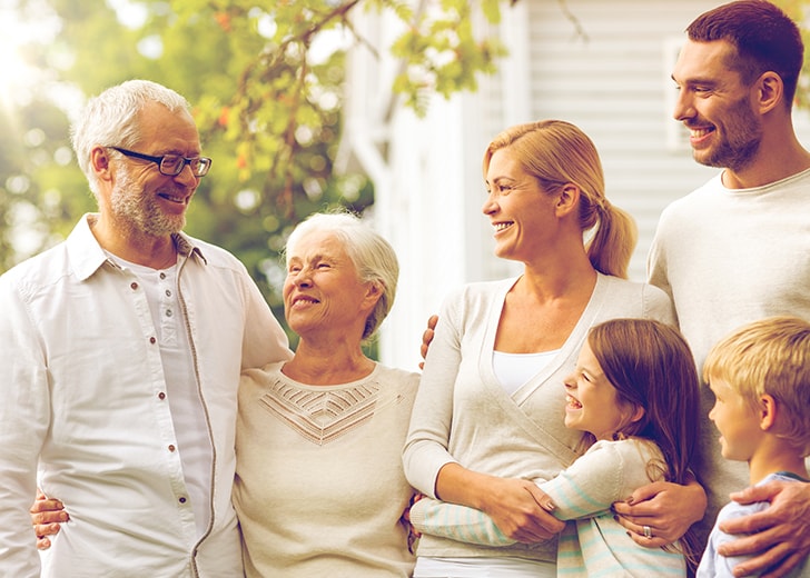 bloodline family smiling and hugging one another for portrait