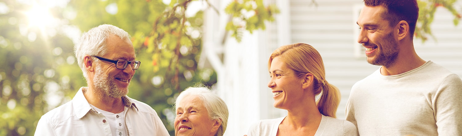 close-up of bloodline family smiling and hugging one another for portrait