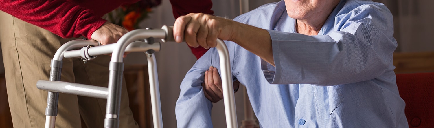 close-up of son helping father with walker