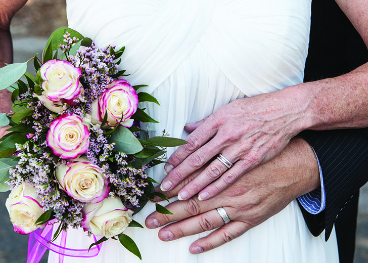 close up of married couple with rings