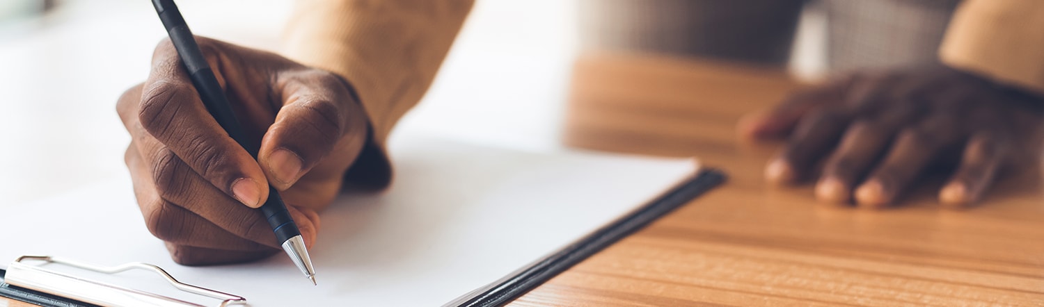 man signing legal documents