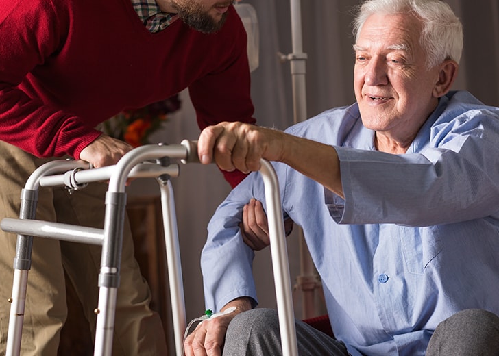 son helping father with walker