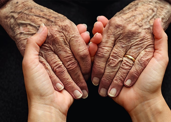 holding senior woman's hand