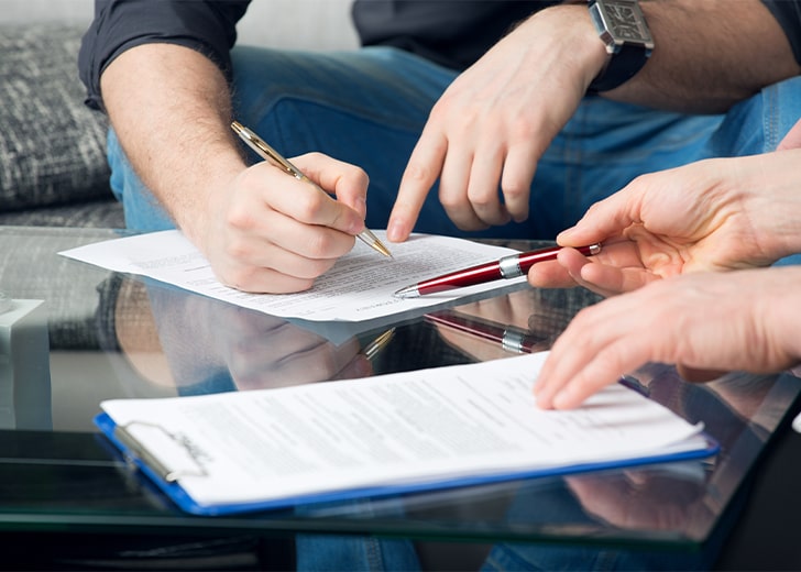 close up of man signing power of attorney document