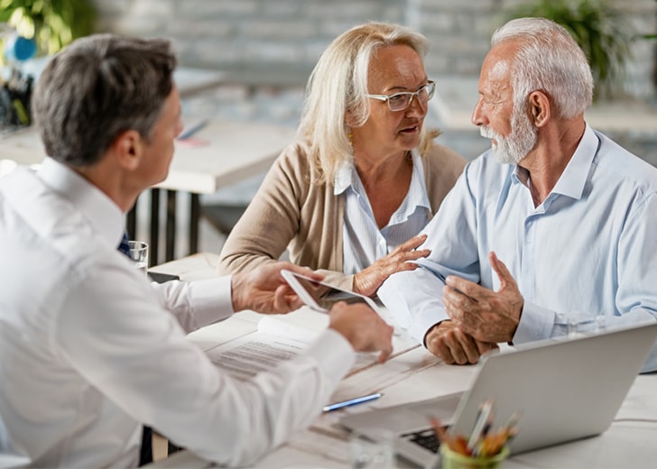 elderly couple meeting with attorney over estate plan