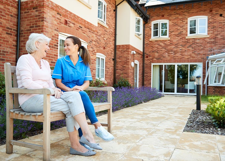 elderly woman in an assisted living facility interacts with a nurse